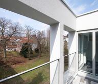 the terrace of a home with the view to a private park